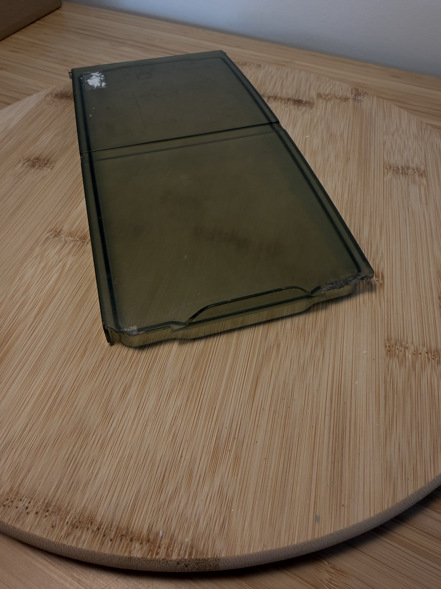The original lid: a smoked, see-through plastic panel with a moulded lip.