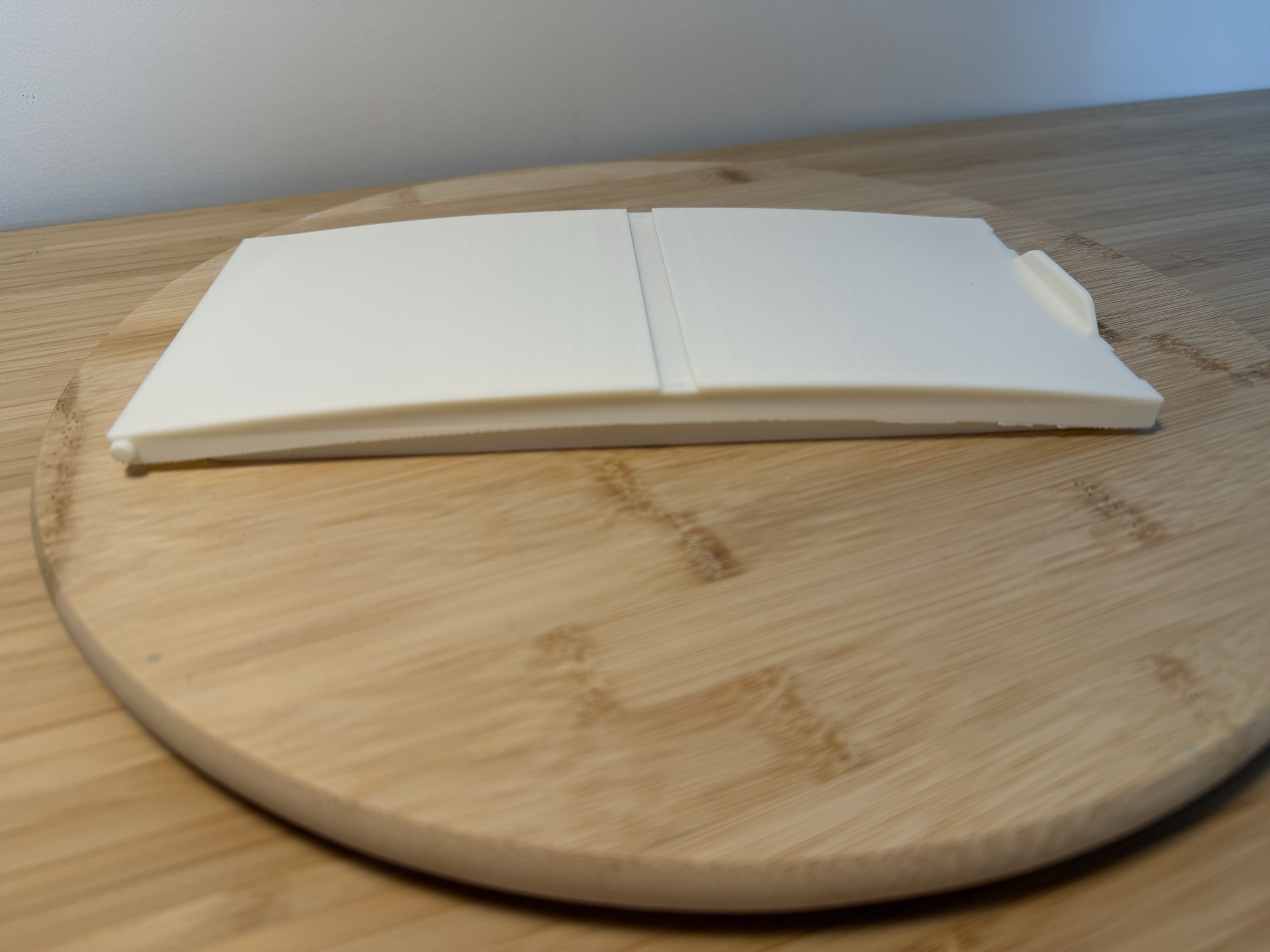The new lid from a low angle, showing its gentle curve.